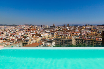 Fototapeta na wymiar Barcelona, Catalonia, Europe, Spain, September 22, 2019. Top panoramic view of the Barcelona landscape from infinity swimmingpool. Historical buildings in the background.
