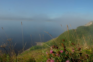 early morning, fog over the river. View from the high Bank