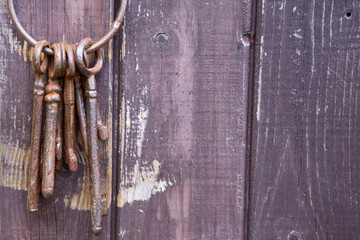 Vintage keys on the background of old wooden doors