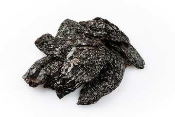 Dried Mexican black hot ancho chili offered as close-up on white background with copy space - free-form select