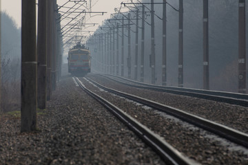 Naklejka na ściany i meble Train on a foggy morning.