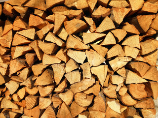 Dry chopped firewood logs in a pile.