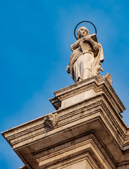 Fototapeta na wymiar Venice, Veneto, Italy- Saint Elizabeth, carved out of stone, stands on the turn of a Catholic church in Venice on a sunny, cloudless day with blue skies in October.