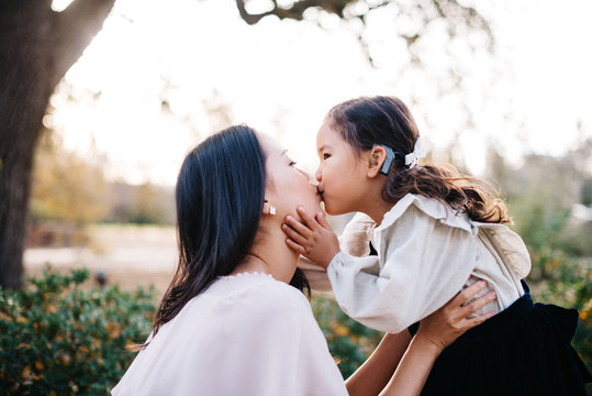 mother and daughter kissing