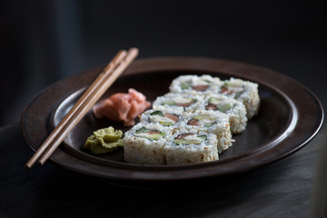 sushi on a brown plate