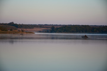 A river in the steppe during the autumn dawn.