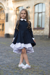 Look sophisticated. Happy child wear uniform in dance position. Back to school fashion. School uniform. Schoolwear. Dress code. Formal education. September 1. Knowledge day. Stay classy