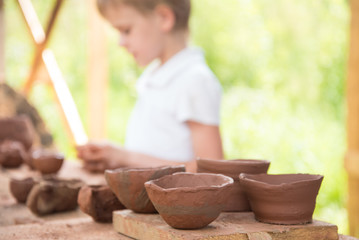 The child makes dishes and various figures from clay. Pottery skills. Hobbies and interests....