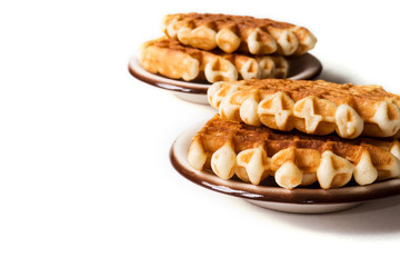 Belgian waffles on small plates on white background.