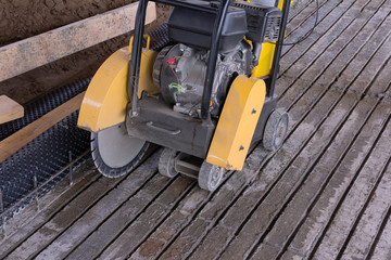 Concrete cutting machine. Equipment for the processing of concrete surfaces. Diamond cutting of materials at the construction site.