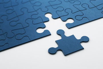Plain blue jigsaw puzzle on white background.