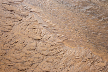 Wet sand texture. Beige sand macro. Dune background close up. Terrain pattern. Sand surface. 