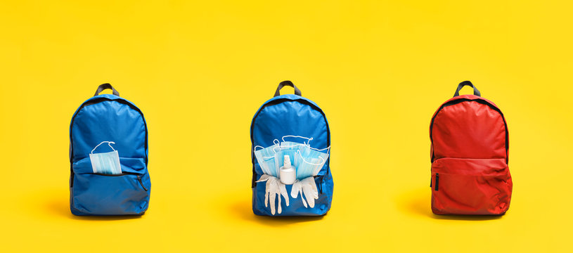 Back to school in pandemic. Backpacks with medical masks, gloves and sanitizer. New normal