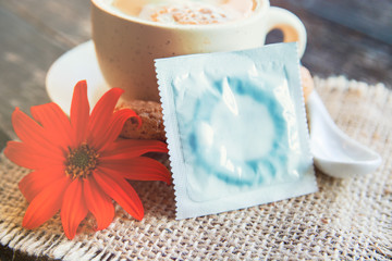cup of aromatic coffee, condom and a bouquet of flowers on white, Romantic date, invitation, sweet wish card text space concept