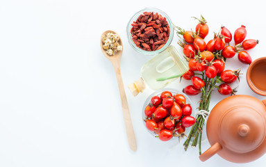 Dog rose, bunch branch Rosehips, types Rosa canina hips and herbal tea - Medicinal plants herbs composition
