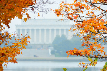 Autumn foliage and Washington D.C. - Lincoln memorial and Potomac River among autumn maple trees.
