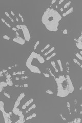 Palm prints. Hand marks. Human prints. DIY decor. Creative interior decoration. Gray wall. Five fingers. Male, female and child hands. Conceptual solution. Human footprint.