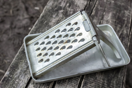 Old kitchen utensils. Metal grater. Things of the Soviet era. Vintage kitchen utensils. Device for chopping food. How to grate vegetables. Household needs. Cook at home. Foldable vegetable grater.