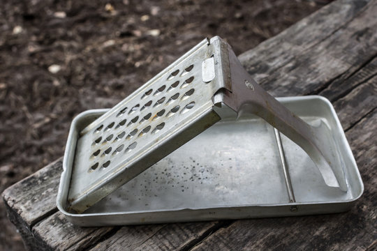 Old kitchen utensils. Metal grater. Things of the Soviet era. Vintage kitchen utensils. Device for chopping food. How to grate vegetables. Household needs. Cook at home. Foldable vegetable grater.