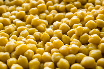 Cooking chickpeas with spices in a pan, close-up