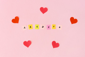 Letters alphabet and hearts around. Love for the english language. Multicolored papers with the abc. Studying of foreign, school lessons. Flat lay.