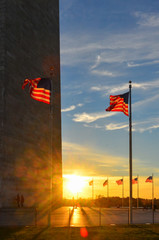 Washington Monument and waving National Flags circling the Monument at sunset - Washington D.C: United States of America
