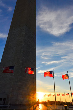 Washington Monument and waving National Flags circling the Monument at sunset - Washington D.C: United States of America