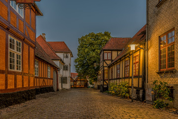 Ancient half-timbered houses at a cobblestone street in the first morning light