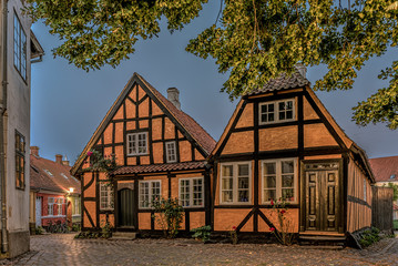 two yellow half-timbered houses in breaking morning