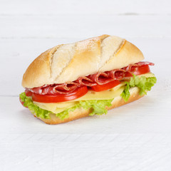 Sandwich with salami ham and cheese fresh square on wooden board