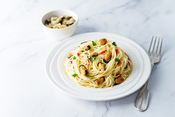 Mussel pasta with pepper and parsley in a plate