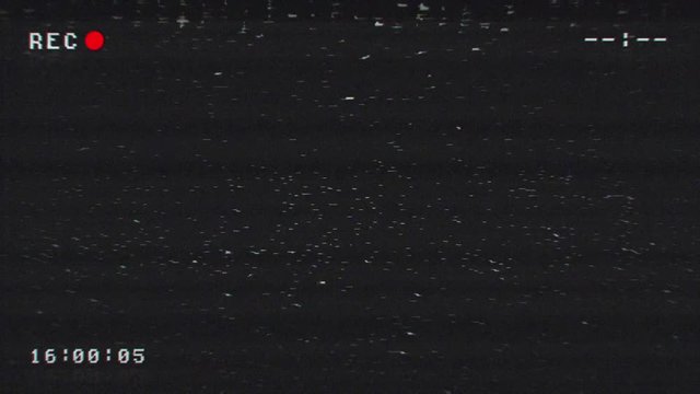 Video Cassette recording. CCTV VHS grainy 4K texture. Analog noise effect. Data, time tracking indicators, blinking record sign in corner, camera markers. Flickering video with signal interference