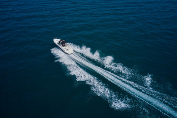 Yachts at the sea surface. Top view of a white boat sailing in the blue sea. Travel - image