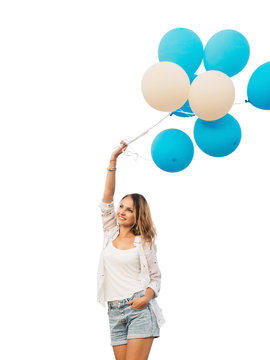 Young woman jumping with blue and white helium balloons isolated on white