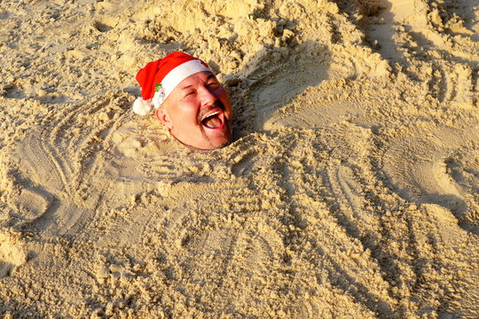 Smiling Santa Claus Is Buried In The Sand 1