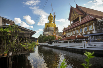 The construction site of the Big golden buddha statue at Wat Paknam temple nearby Phasi charoen canal in Bangkok Thailand 