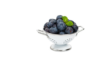 Blueberries in a Colander Isolated on white background. Selective focus.