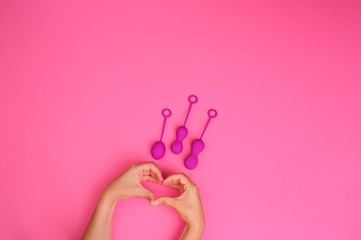 woman holds a kegel trainer. Latex vaginal vibrator for training the pelvic floor muscles with an...