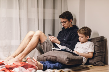 Father and Son Reading a Book in a Cozy Room