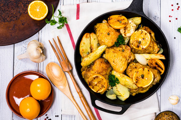 Chicken Thighs Roasted with Meyer Lemon and Potatoes. Selective focus.