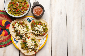 Mexican nopal cactus tacos with cheese on white background