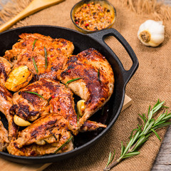 Braised Fried Rabbit with Rosemary, Garlic and Olive Oil on Wooden Background. Selective focus.