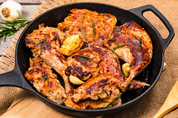 Braised Fried Rabbit with Rosemary, Garlic and Olive Oil on Wooden Background. Selective focus.