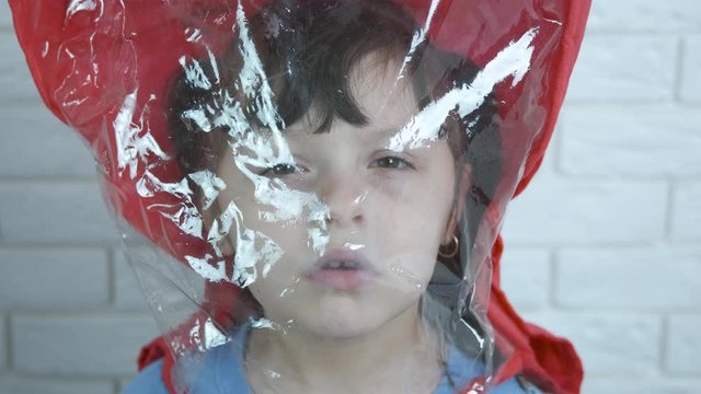 Little girl in a cellophane bag.