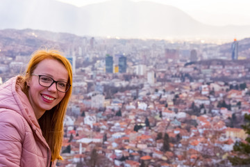 Girl smilling above the cityscape of Sarajevo capital of Bosnia and Herzegovina