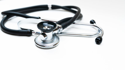 Black Stethoscope and phonendoscope isolated on white close up. Selective focus. Medical concept. 