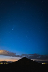 Comet NEOWISE brightens the northern sky over Cone Mountain near Phoenix, Arizona.