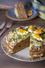 Layered liver cake with cheese, mayonnaise and dill. Savory cake. vertical photo
