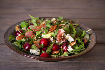 Strawberry and prosciutto salad with gorgonzola cheese and arugula. Healthy food. horizontal photo