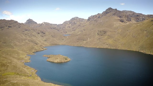 Drone flying over Andes mountains and lake in Parque Nacional Cajas, Ecuador